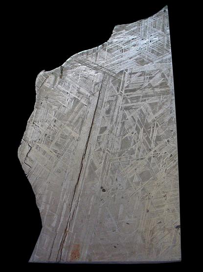 Photo of a polished and etched disc of an iron meteorite (Gibeon meteorite), Octahedrite with Widmanstätten patterns, Gibeon, Southwest Africa, 1836; Staatliches Museum für Naturkunde Karlsruhe, Germany. 

Full image source & credit:
https://commons.wikimedia.org/wiki/File:Eisen_-_Meteorit_02.jpg