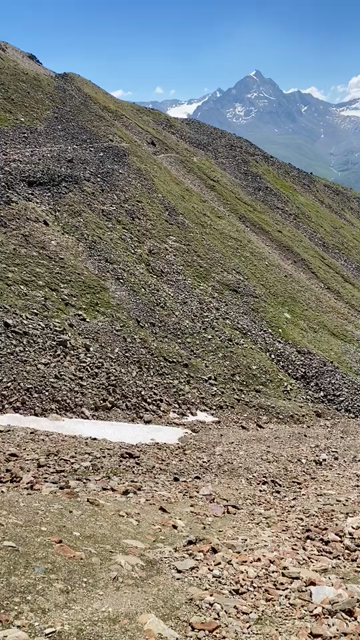 Short POV video of a person walking along a narrow path in an high alpine landscape, the glaciated peaks of the Kreuzkamm on the opposite side of the valley, and Mitterkar and Wildspitze (our side), Tyrol's highest mountain directly above us...