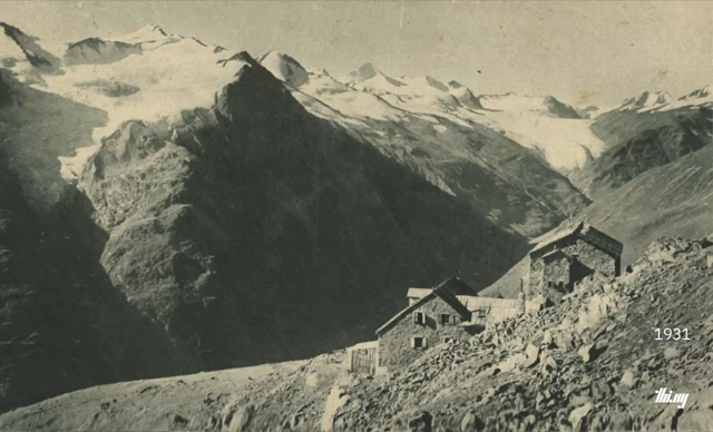 Cross-fade animation between two photographs of Breslauer Hütte and the mountain peaks and glaciers of the Kreuzkamm ridge in the background. One photo is from ~1931, the other from 2026. Both images are aligned as best as can be, the cross-fade better highlighting the drastic changes (climate change) to the hut and these dramatic glaciated peaks.